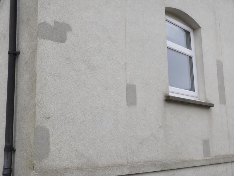 Cracks in exterior render being repaired before a new coating is applied